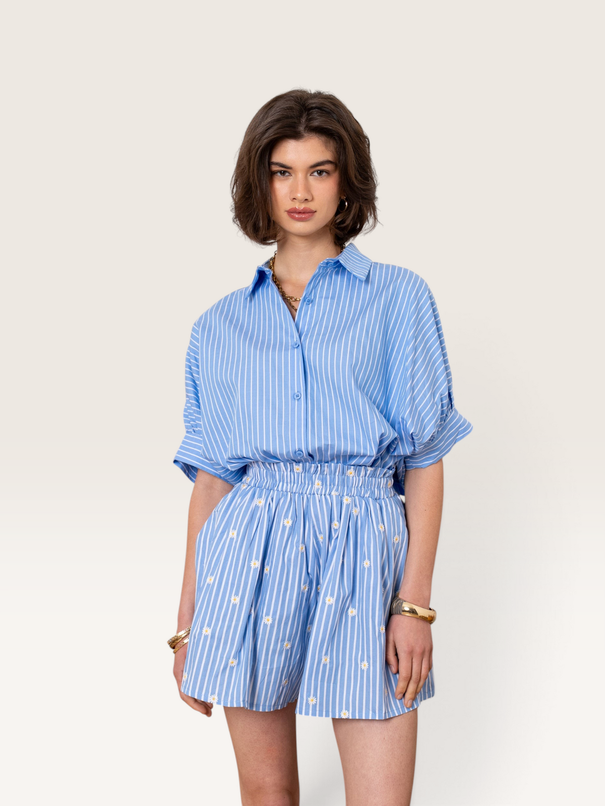 Ensemble Sable_blanc_collection composé d'une chemise bleue à rayures et d'un short assorti à motifs fleurs