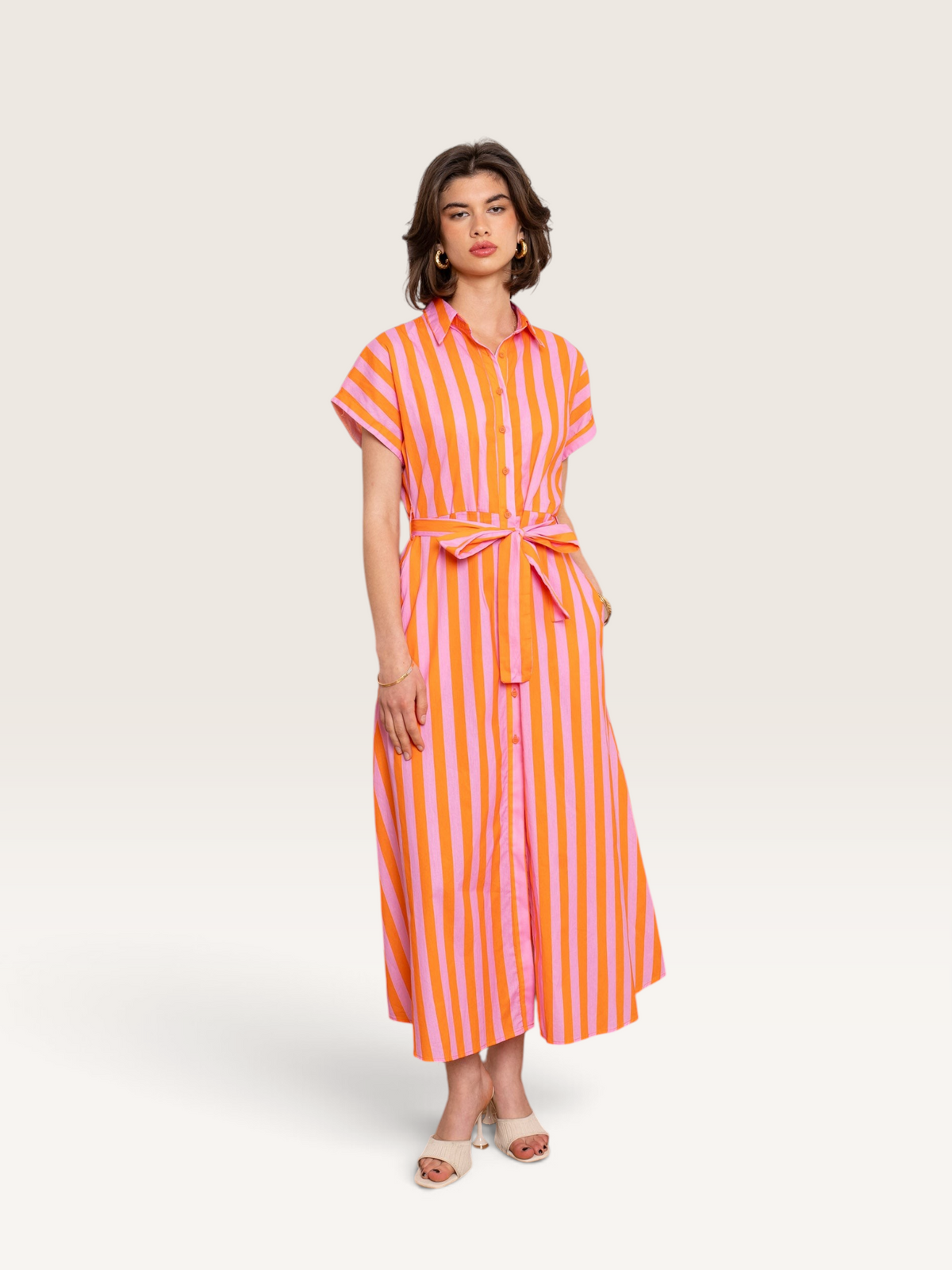 Modèle portant une robe chemise Sable_blanc_collection rayée rose et orange en coton avec ceinture à nouer